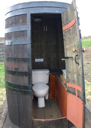 Award-winning converted whiskey barrel glamping loo